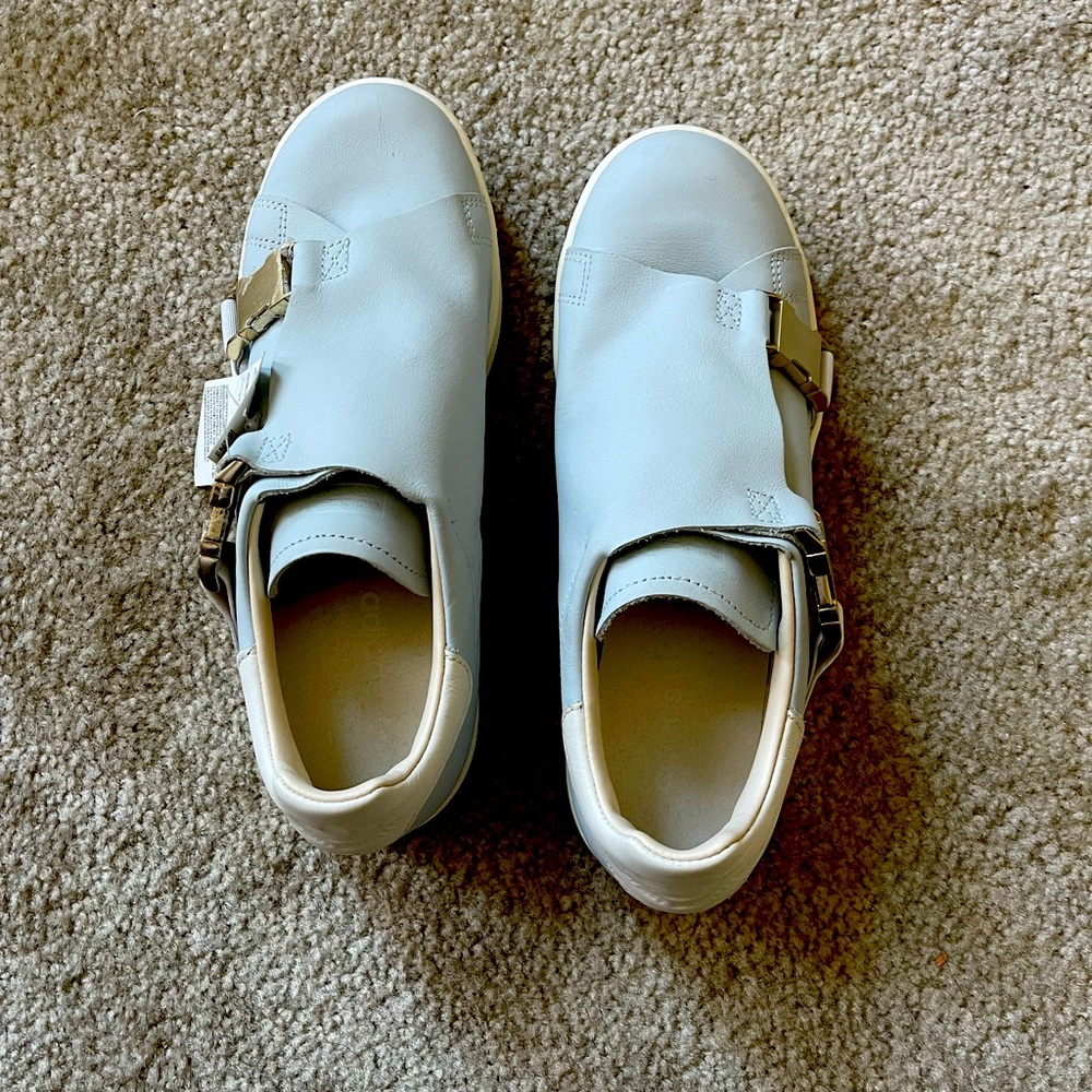 Adidas- light blue Stan Smiths with gold buckle.